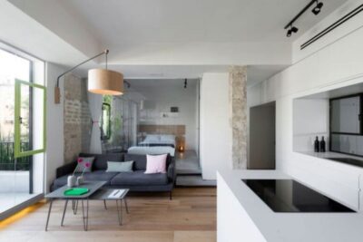 Tel Aviv apartment with Japanese design influences bedroom behind sofa