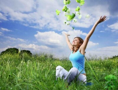 happy woman tossing up leaves