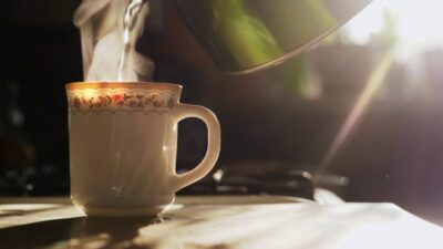 videoblocks kettle pouring boiling water into a cup during breakfast in morning sunlight in slowmotion sunlight and glare through the kitchen window hh7gsb0khz thumbnail full04